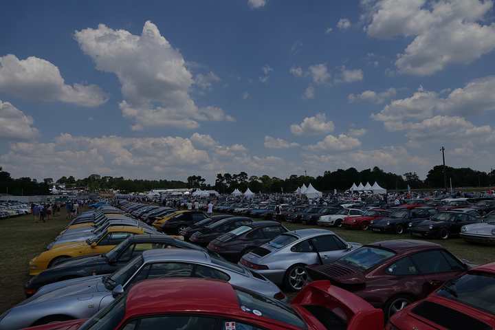 Rows of Porsches in a club parking area at Le Mans Classic in 2018