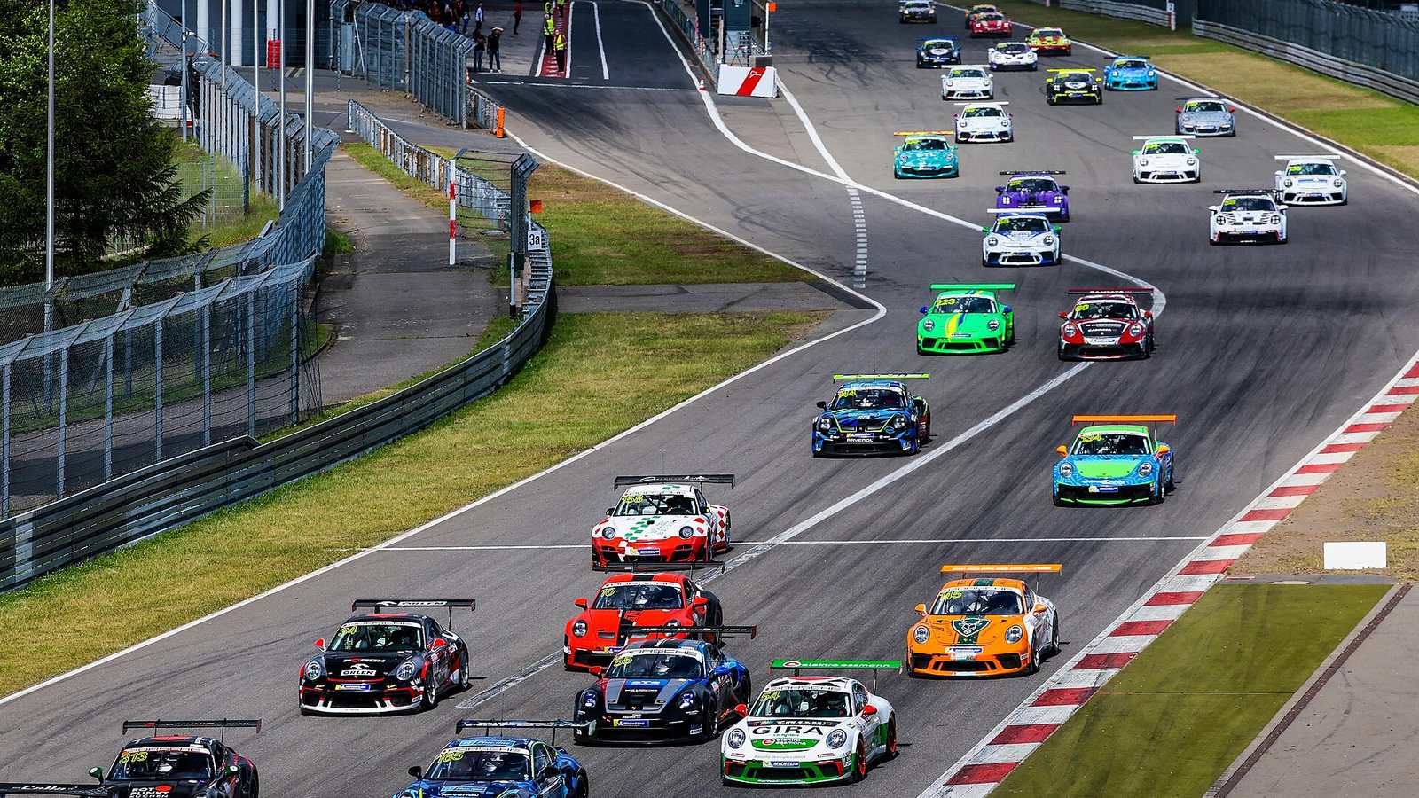 A grid of Porsche 911 Cup cars at the start of a race at the Nürburgring