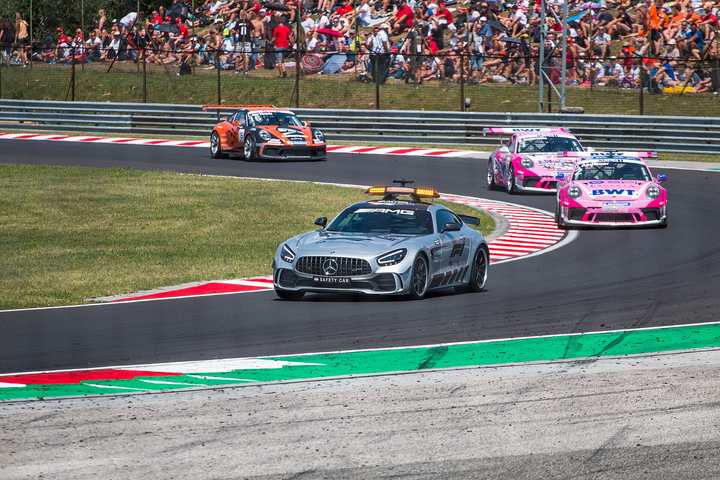 Porsche 911 GT3 Cup cars following the safety car at the Hungaroring during a Porsche Supercup race in 2019