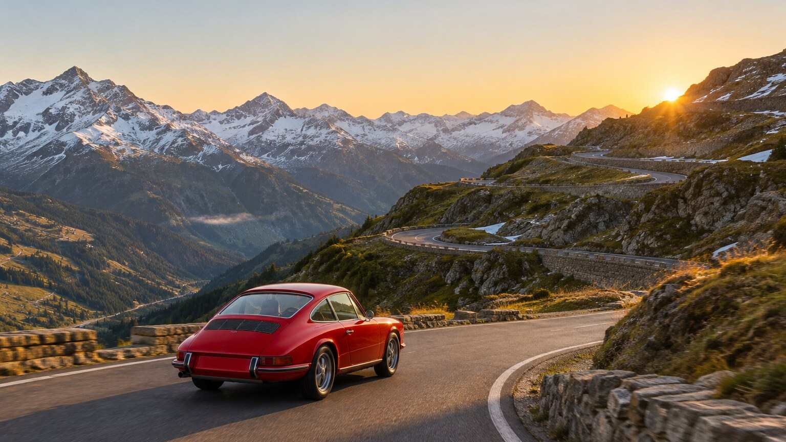 A red rear-engined sports coupé climbing a winding alpine pass at sunrise