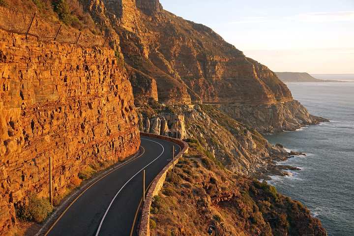 Chapman's Peak Drive cut into red cliffs above the Atlantic Ocean