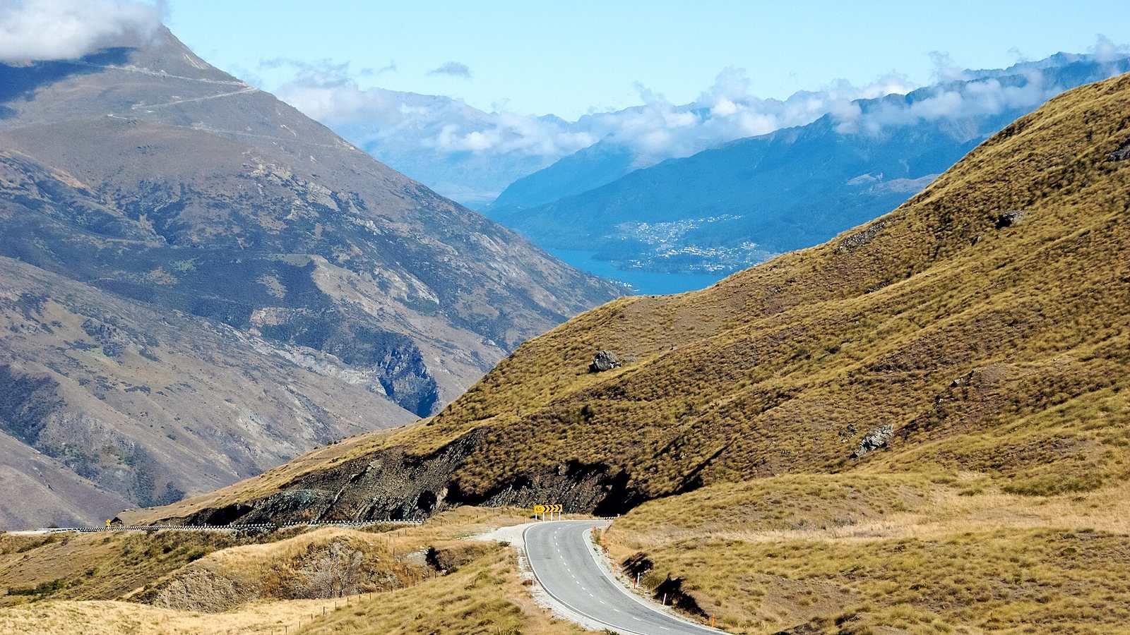 The Crown Range Road curving across tussock hills above Queenstown