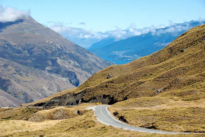 The Crown Range Road curving across tussock hills above Queenstown
