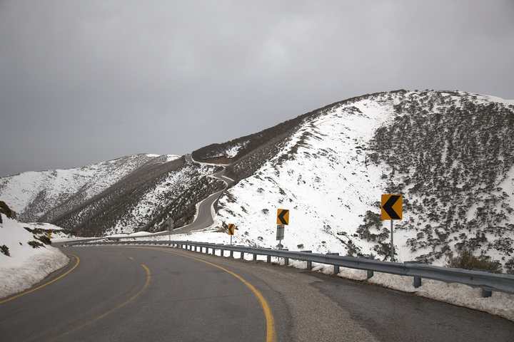 The Great Alpine Road crossing a snow-dusted ridge near Mount Hotham